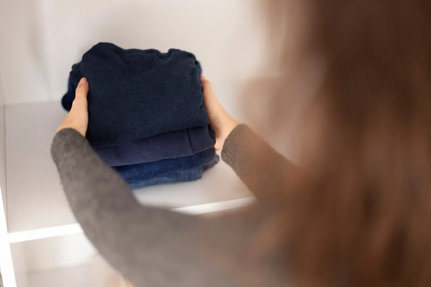 Close-up of a woman holding clothes.